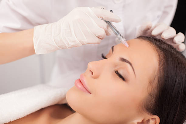 istock Professional cosmetologist is making procedure at clinic 493975378