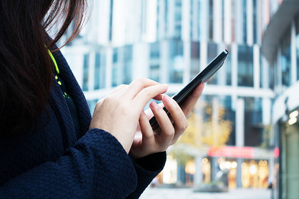 istock Close-up of woman's hands with smartphone 493977194