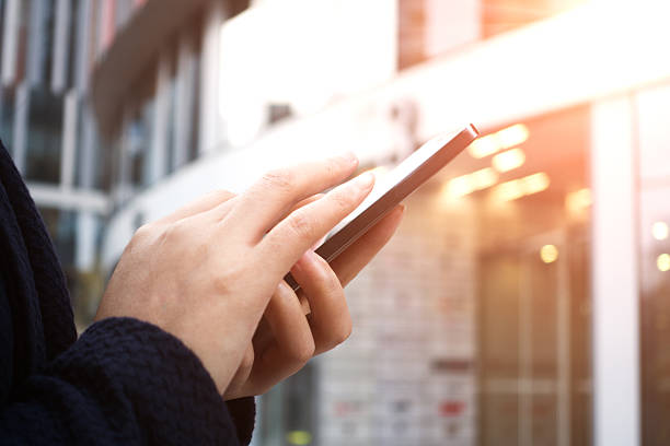 istock Close-up of woman's hands with smartphone 493977372