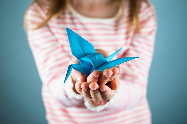 istock Girl holding a paper crane 493978725