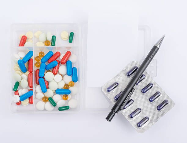 istock Pills in glass box and ballpoint pen with blank sheet 493979252