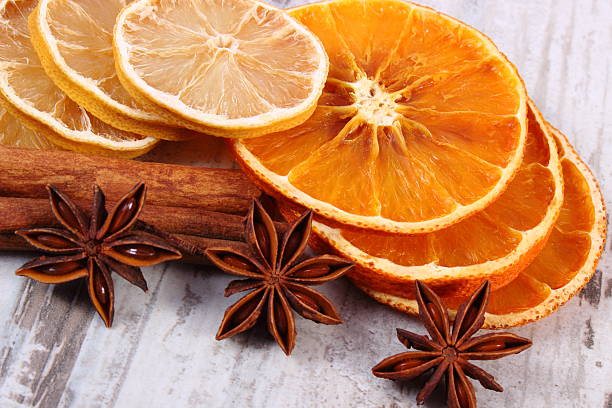 istock Dried lemon, orange and spices on old wooden background 493979448