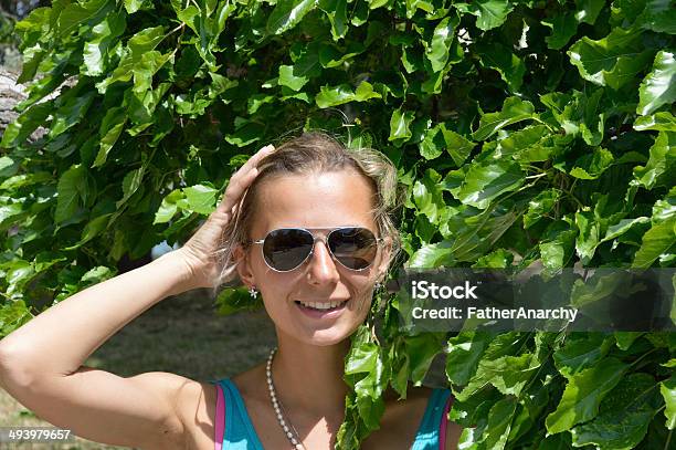 Beautiful Girl In Branches Of Baytree Stock Photo - Download Image Now - Adult, Adults Only, Beautiful Woman