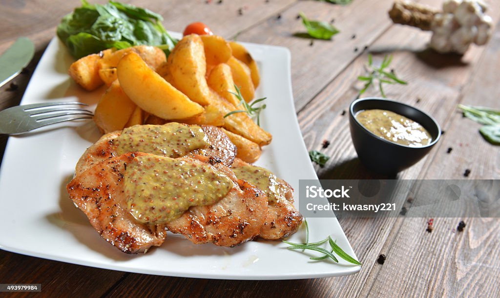 Turkey breasts with honey-mustard sauce Turkey breasts with honey-mustard sauce and roasted potatoes Chicken Meat Stock Photo