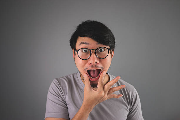 istock Funny Asian man is whipping his mouth. 493980016