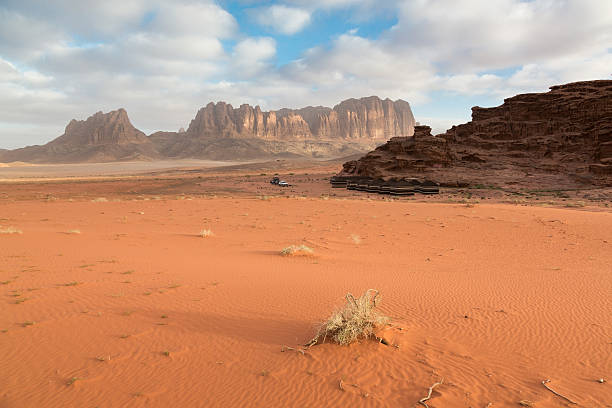 Wadi Rum also known as The Valley of the Moon is a valley cut into the sandstone and granite rock in southern Jordan 60 km (37 mi) to the east of Aqaba; it is the largest wadi in Jordan. The name Rum most likely comes from an Aramaic root meaning 'high' or 'elevated'. The area is now one of Jordan's important tourist destinations, and attracts an increasing number of foreign tourists, particularly trekkers and climbers, but also for camel and horse safari or simply day-trippers from Aqaba or Petra.