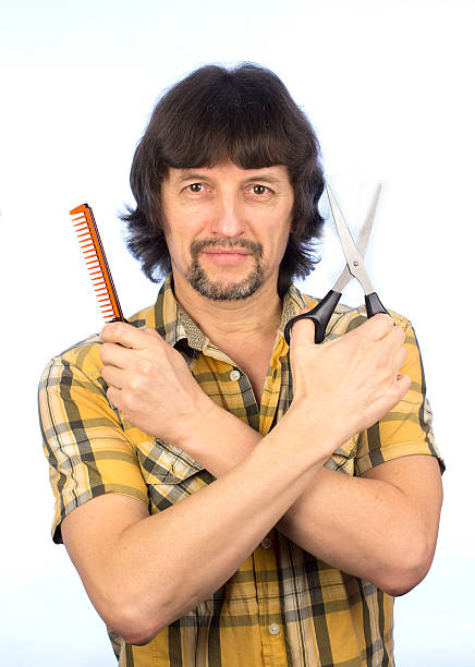 istock The man with scissors and comb in his hands 493981436