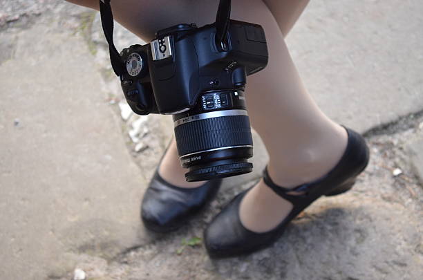 istock AlPretty young photographer - frame from a legs 493982687