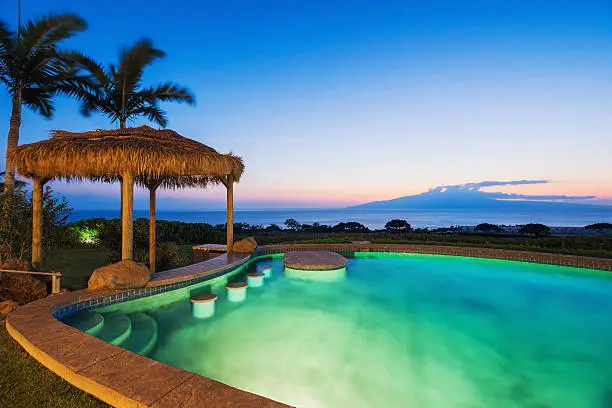 Luxury home with swimming pool at sunset