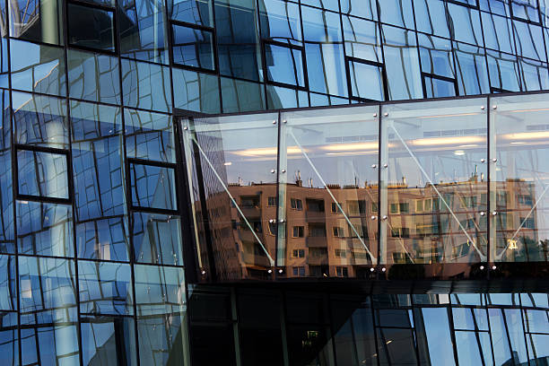 istock Reflection of community housing in a modern office building 493984081