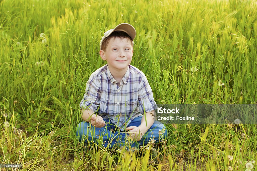 Boy on summer nature with dandelions Boy on summer nature with dandelions smilling Blond Hair Stock Photo