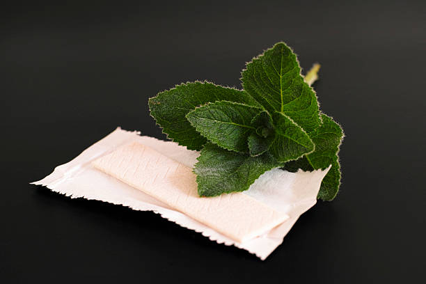 Chewing gym and mint Chewing gyms and fresh mint on black background mint chewing gum stock pictures, royalty-free photos & images