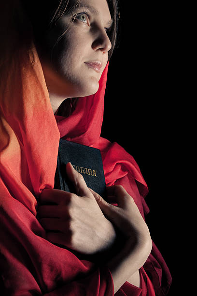 istock Woman with a Bible in the night. 493985847