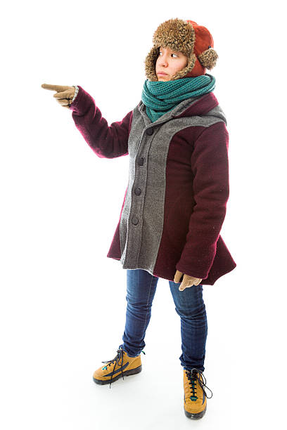 istock Young woman in warm clothing and pointing 493985995