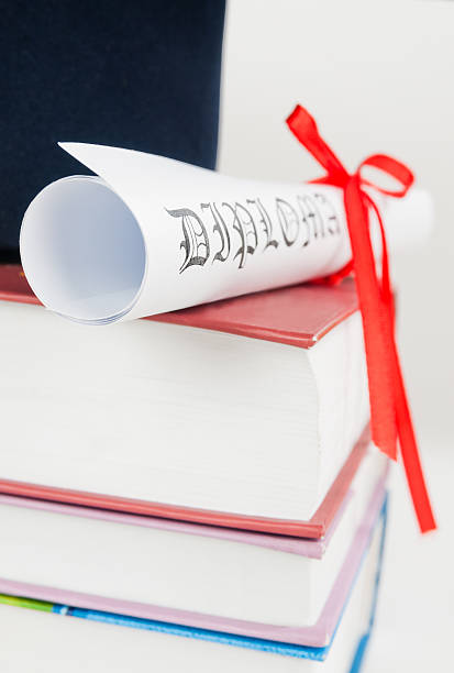 istock Graduation cap with book and diploma 493993468
