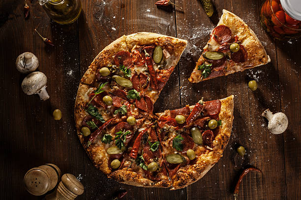 istock top view of fresh baked pizza with slice 493994904