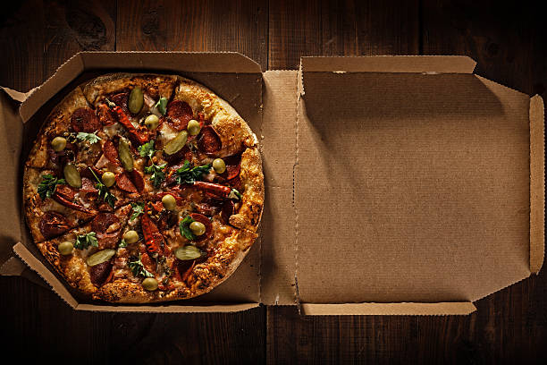 istock pizza in the in delivery box on the wood 493995154