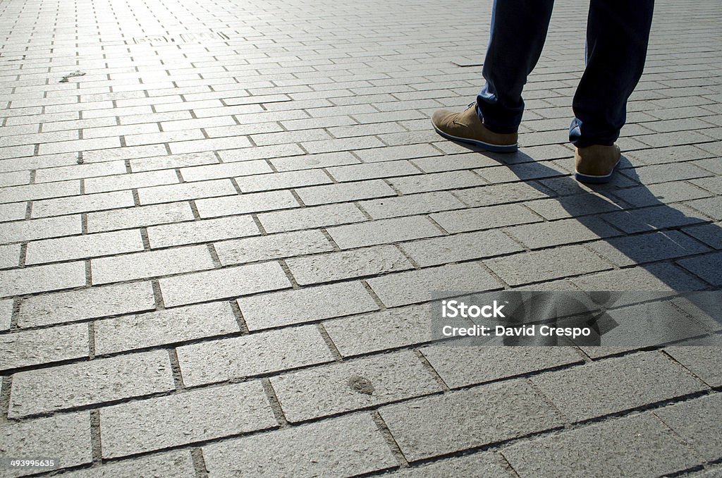 Another working day Morning sun casting the shadow of a man passing by. Activity Stock Photo