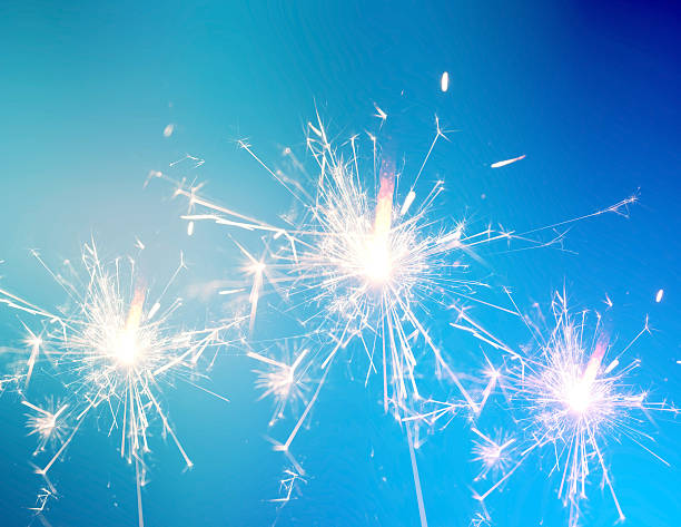 istock Burning christmas sparkler on blue background 493997538