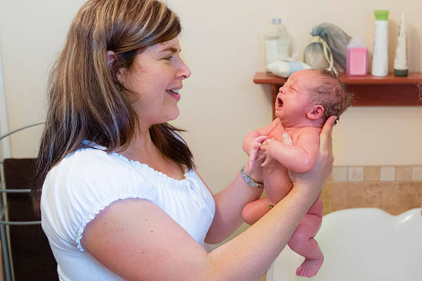 istock Mom holding her newborn baby after bath 493998107