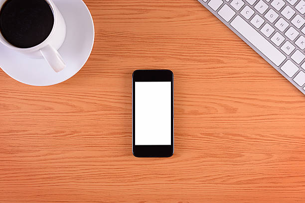 istock Blank white screen smart phone on office desk 493998293