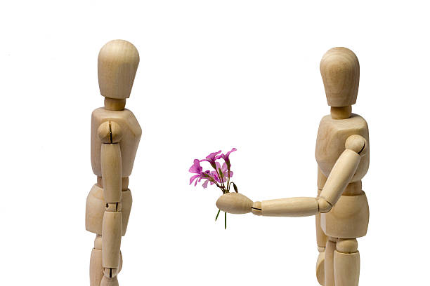 istock Male puppet brings woman some flowers 493999938