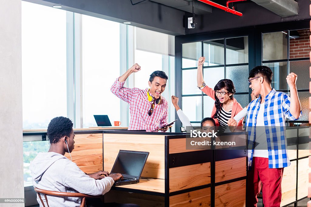 Start-up business people in cubicles Start-up business people in cubicles working together having success 2015 Stock Photo