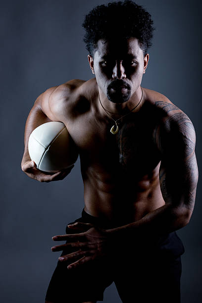 istock Muscular man running with rugby ball 494001202