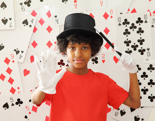 young magician with magic wand stock photo