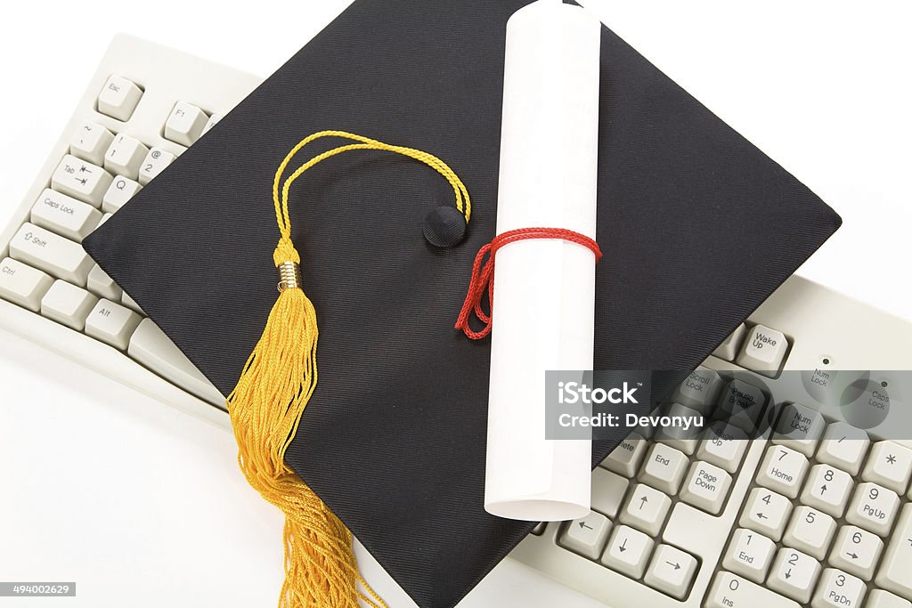 Black Mortarboard and computer keyboard Black Mortarboard and computer keyboard, online learning Computer Keyboard Stock Photo