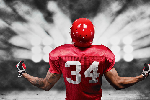 Rear view of American football player cheeringhttp://www.twodozendesign.info/i/1.png
