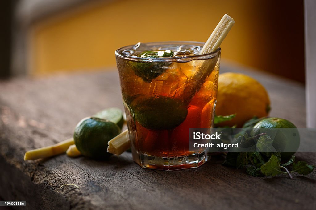 Cocktail glass Cocktail glass on wooden table with lime and lemon Rum Stock Photo