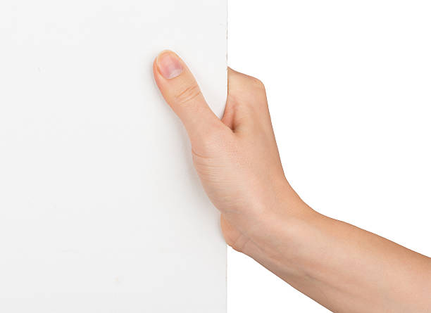 istock Womans hand holding edge of blank paper 494006468
