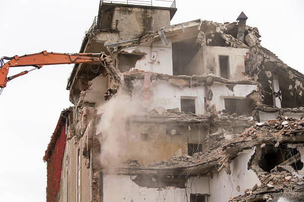 istock Building demolition and crashing by machinery for new construction. 494027226