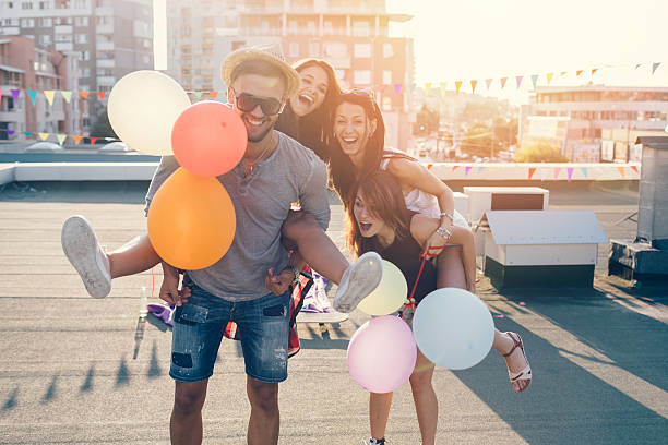 istock Friends piggyback on the rooftop 494028114