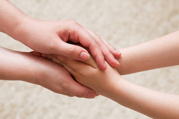 istock hands of mother and daughter 494029438