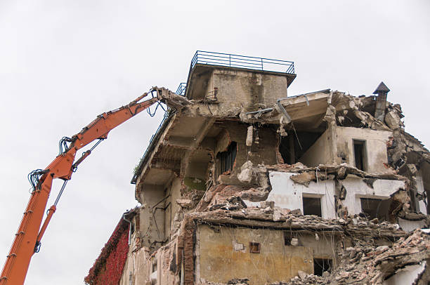 istock Building demolition and crashing by machinery for new construction. 494030116