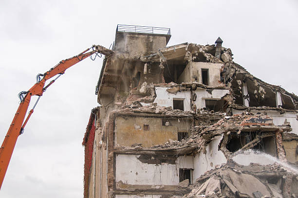 istock Building demolition and crashing by machinery for new construction. 494030150