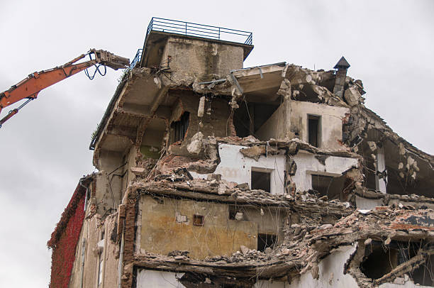 istock Building demolition and crashing by machinery for new construction. 494030254