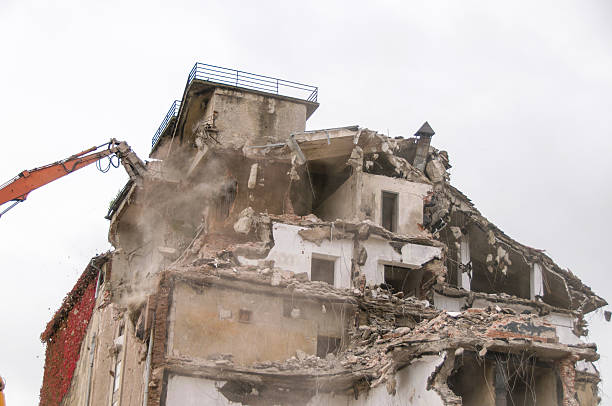 istock Building demolition and crashing by machinery for new construction. 494030552