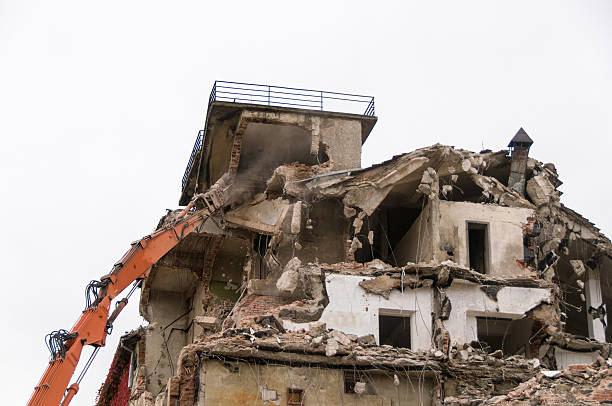 istock Building demolition and crashing by machinery for new construction. 494030942