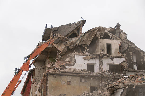 istock Building demolition and crashing by machinery for new construction. 494031302