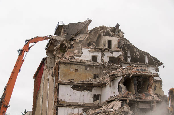 istock Building demolition and crashing by machinery for new construction. 494031386