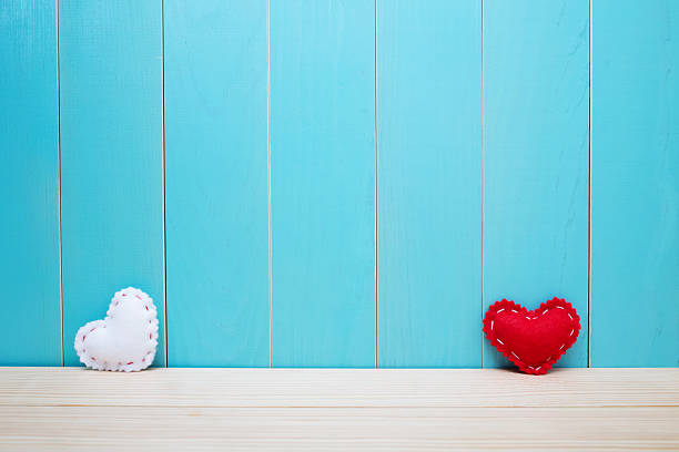 istock Hand crafted red and white felt hearts on blue background 494033380