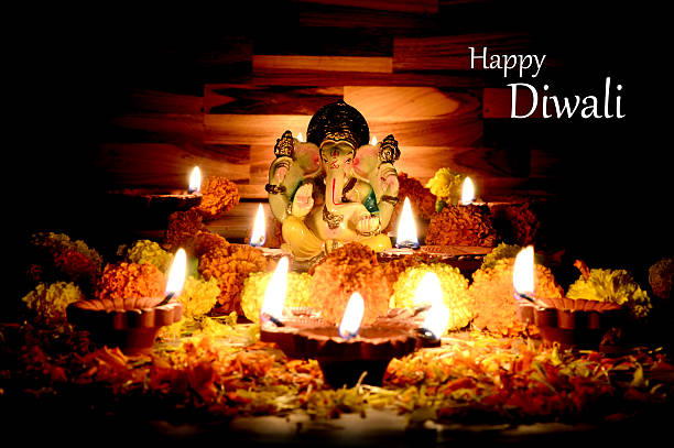 istock Clay diya lamps lit with Lord Ganesha during diwali celebration. 494035476
