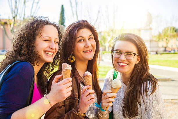 istock Three women eating an ice cream outdoor 494035537