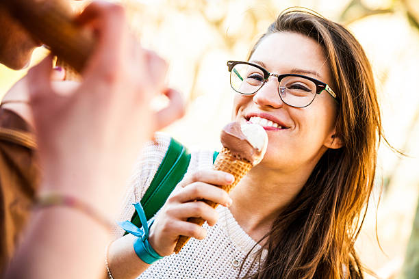 istock Women eating an ice cream outdoor 494035539