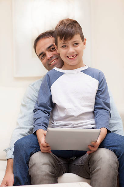 istock father and son on the couch 494036850