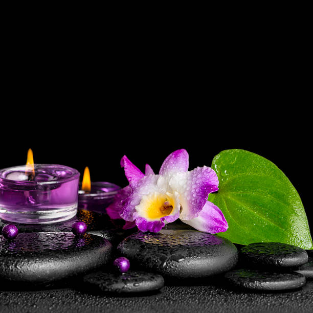 istock spa concept of purple orchid dendrobium, leaf with dew,  candles 494037102