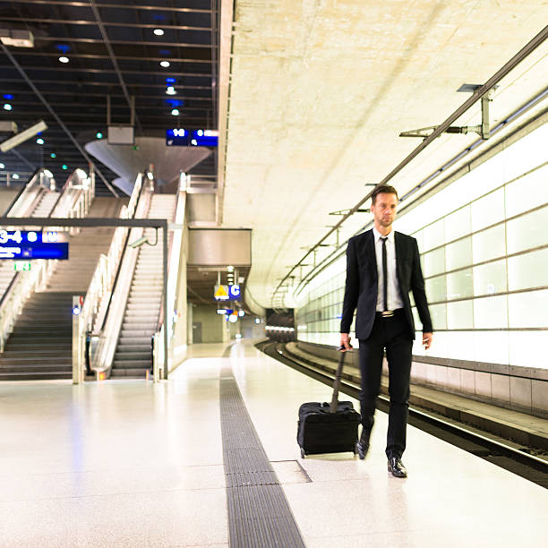 istock businessman walking on the train station 494037386